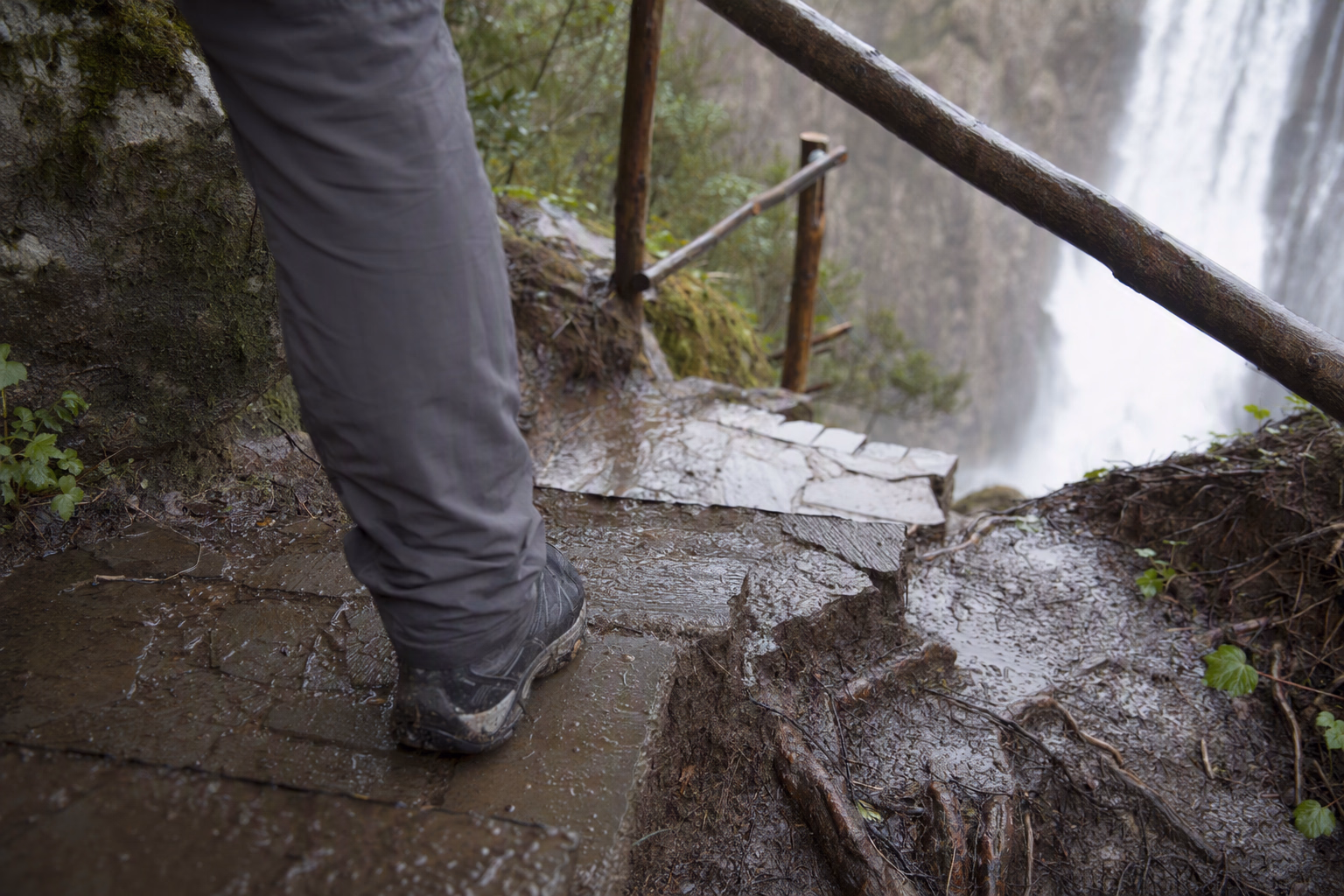 Field-note composition of trail shoes, rain cover and a daylight turn-around marker